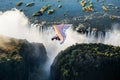 Tourists fly over the Victoria Falls on the trikes. Royalty Free Stock Photo